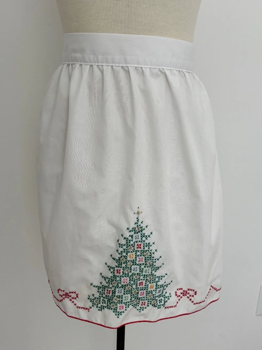 Vintage white half apron featuring hand-stitched cross-stitch Christmas trees